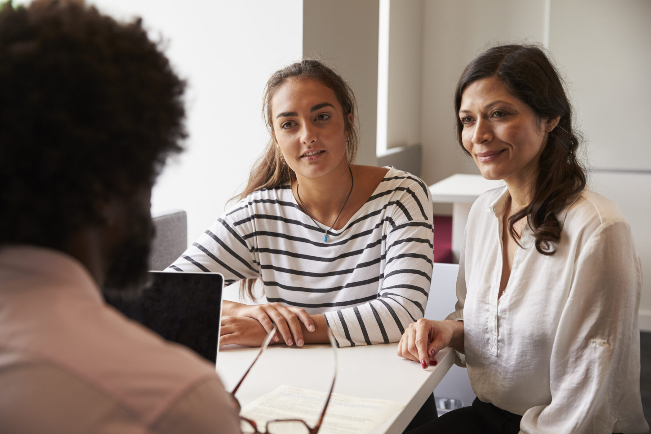 mother/daughter meeting college advisor to discuss transition of child going to college.